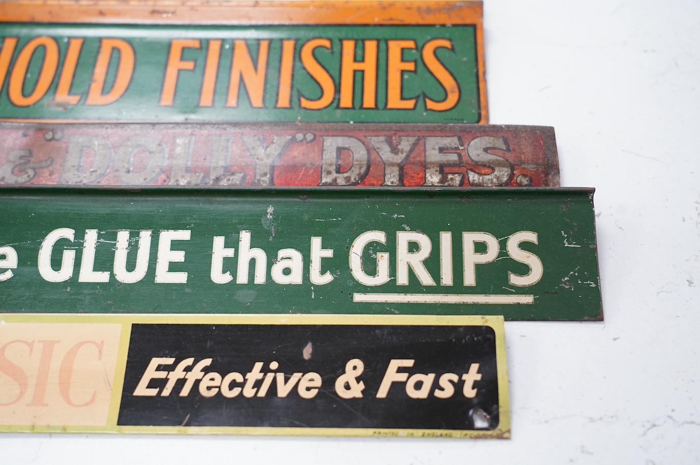 Eleven early / mid century tinplate advertising shelf strips, largest 60cm. Condition - poor to fair